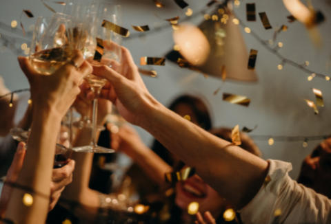 Christmas party guests raising glasses